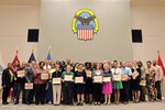 DLA Troop Support employees pose for a photo with Commander Army Brig. Gen. Charles Hamilton (in uniform, left of center) at a quarterly awards ceremony June 6. The employees received certificates of appreciation for their contributions to Troop Support’s Take Our Daughters and Sons to Work Day in April. Photo by Shannon Frady.