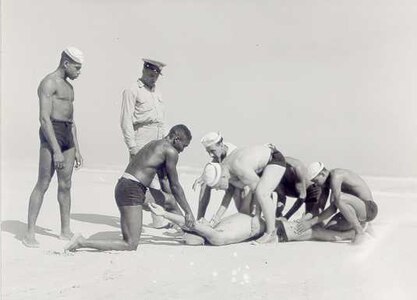 Coast Guard Station Tiana, Hampton Bay, Long Island, New York 1942-1944
"APPLYING ARTIFICIAL RESPIRATION TO 'VICTIM' AT TIANA LIFEBOAT STATION."
Courtesy of Kenneth Sutherland
