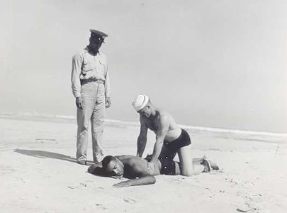 Coast Guard Station Tiana, Hampton Bay, Long Island, New York 1942-1944
"APPLYING ARTIFICIAL RESPIRATION TO 'VICTIM' AT TIANA LIFEBOAT STATION."
Courtesy of Kenneth Sutherland
