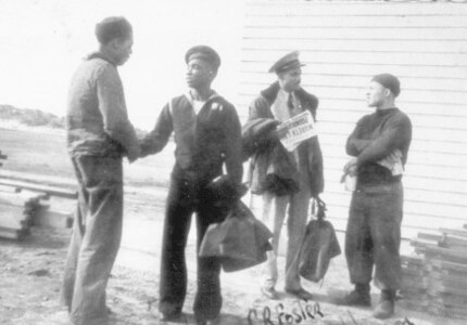 Coast Guard Station Tiana, Hampton Bay, Long Island, New York 1942-1944
Knight (second from left); CBM Foster (holding paper); C.B. Johnson (far right)."  
Courtesy of SSgt. Johnson.


