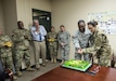 Maj. Gen. Marion Garcia, commanding general of the 200th Military Police Command, chops down on a congratulatory cake with the help of Spc. Derrick Bonney, personnel specialist, during a surprise celebration for her promotion to major general at Fort Meade, Maryland, June 8. (U.S. Army Reserve photo by Master Sgt. Michel Sauret)