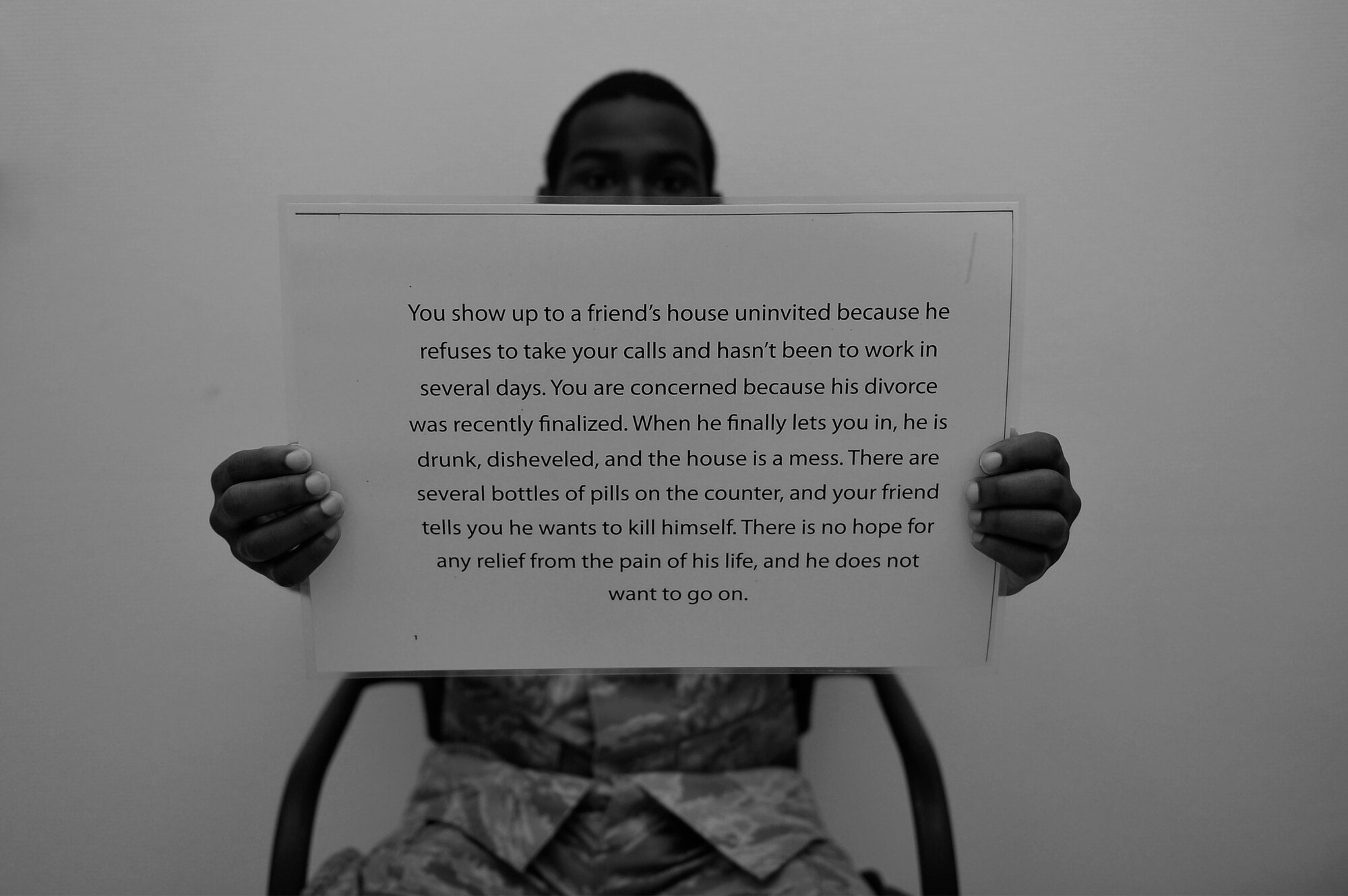 U.S. Air Force Senior Airman Larry Scott, 86th Material Maintenance Squadron material readiness spare packages journeyman, holds up a written scenario on Ramstein Air Base, Germany, June 7, 2017. The Air Force Green Dot program is annual training designed to teach Airmen to prevent interpersonal violence in their communities. (U.S. Air Force photo by Airman 1st Class Joshua Magbanua)