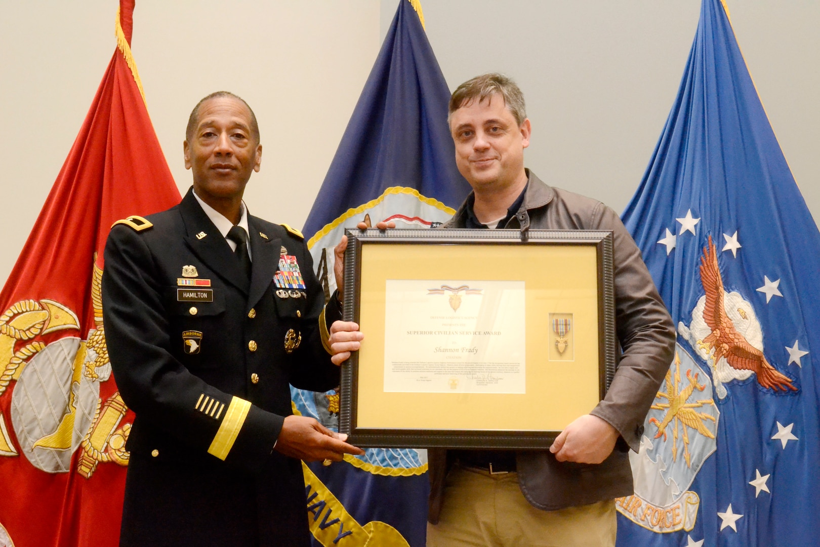 DLA Troop Support commander Army Brig. Gen. Charles Hamilton presents a Civilian Superior Service Award to Shannon Frady, a Troop Support visual information specialist, during a quarterly awards ceremony June 6. Frady was among 67 Troop Support employees recognized for the contributions to the warfighter-support mission.