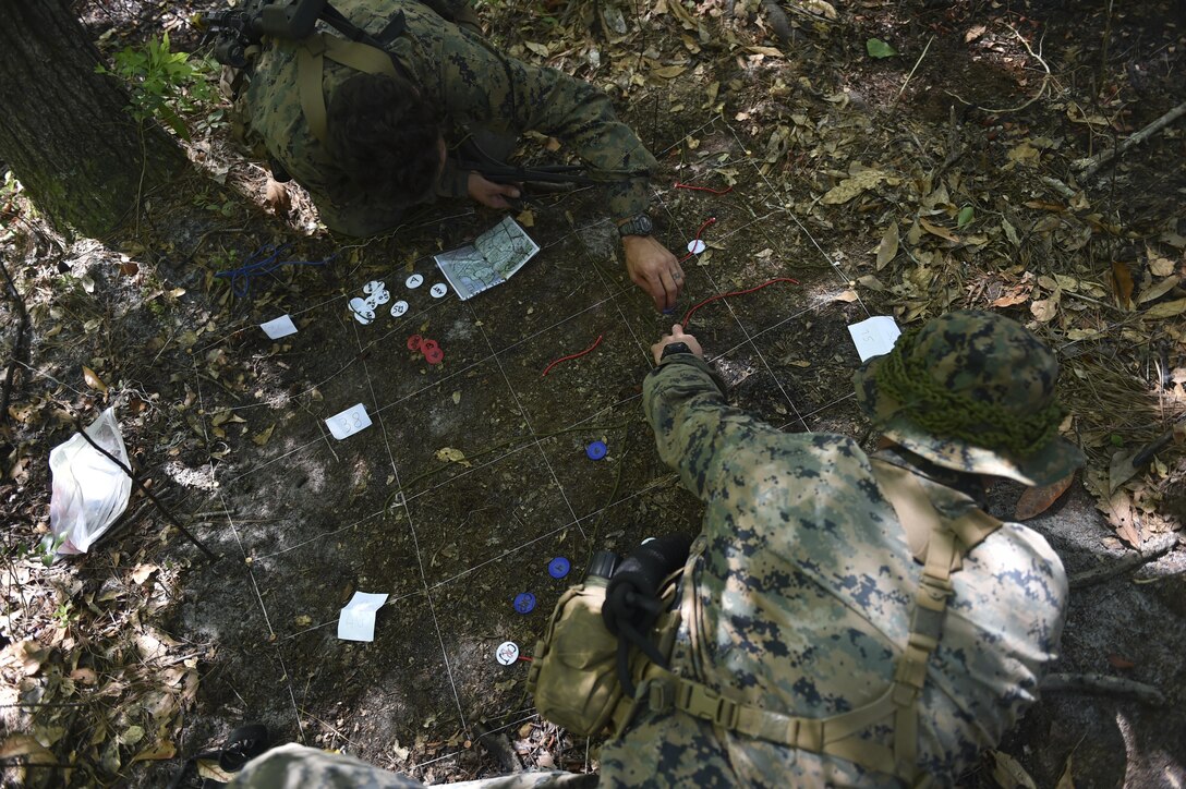 Marine Special Operations School Individual Training Course students plan a mission during Field Training Exercise Raider Spirit, May 3, 2017, at Camp Lejeune, N.C. For the first time, U.S. Air Force Special Tactics Airmen spent three months in Marine Special Operations Command’s Marine Raider training pipeline, representing efforts to build joint mindsets across special operations forces.  (U.S. Air Force photo by Senior Airman Ryan Conroy)