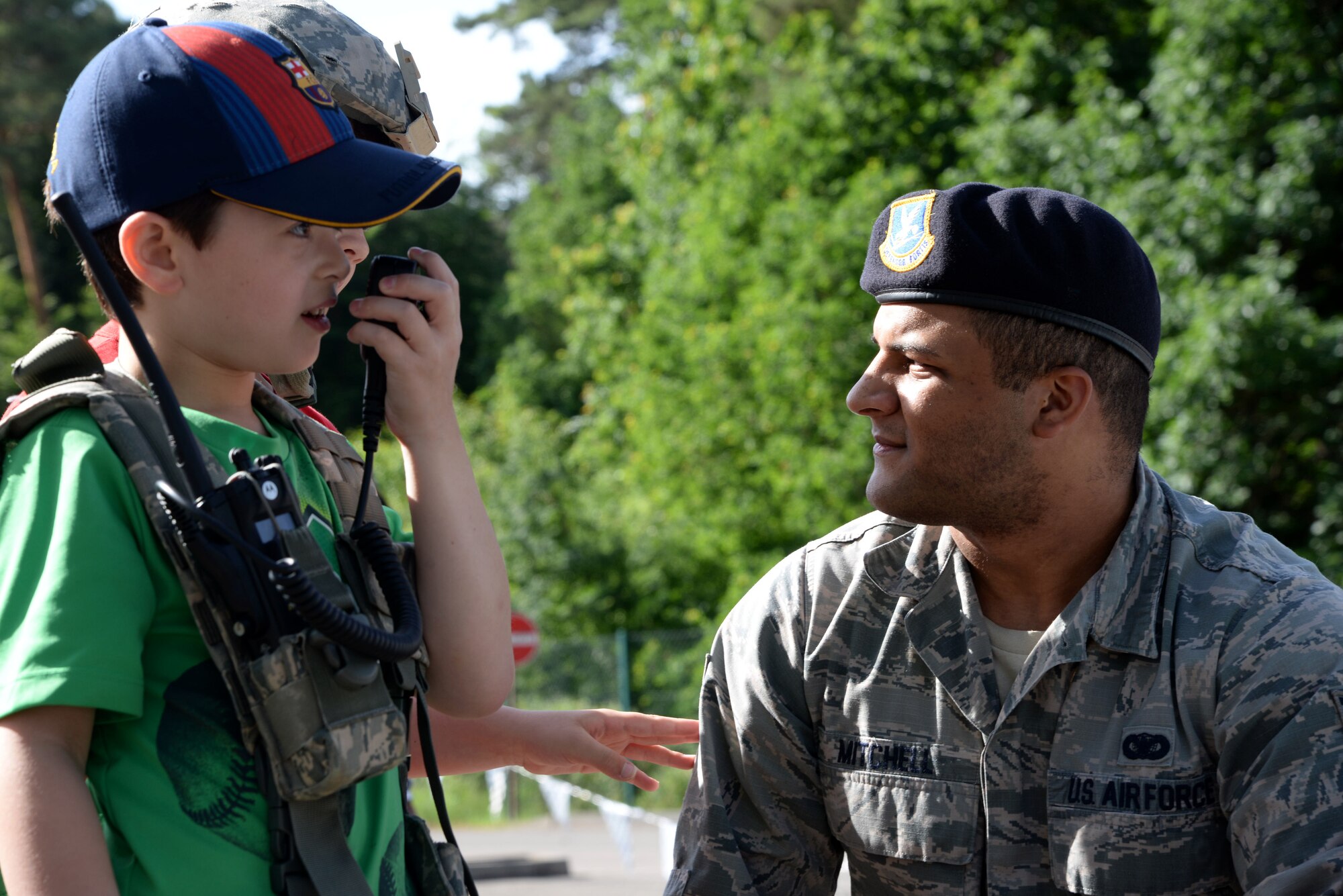 Senior Airman Tevin Mitchell, 86th Security Forces Squadron armorer, shows students how to use the radio at Ramstein Elementary School’s June Bug Out field day on Ramstein Air Base, Germany, June 8, 2017. Groups of approximately 30 children at a time came to watch 86th SFS Airmen speak on their duties as police officers. (U.S. Air Force photo by Airman 1st Class D. Blake Browning)