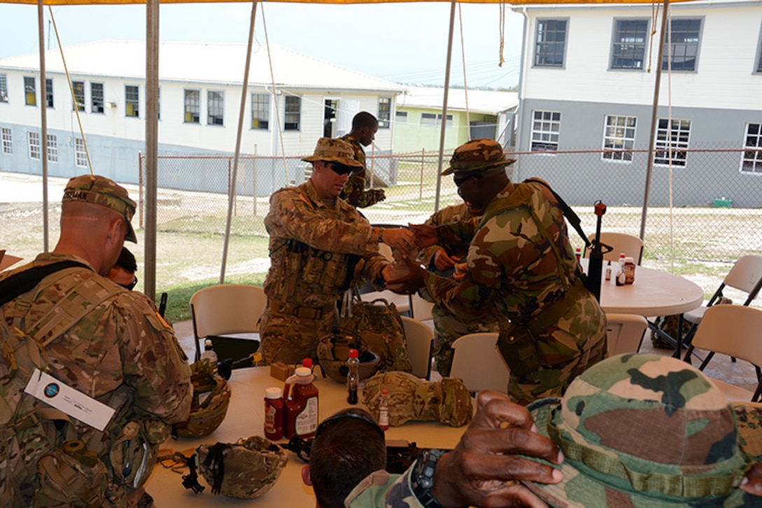 Sgt. 1st Class Samuel Amador, an Infantryman with the 1/124th Infantry Regiment, 83rd Infantry Combat Brigade Team, Florida Army National Guard, distributes training ammunition to a member of the Barbados Defence Force who is participating in Tradewinds 2017 at Paragon Base, Barbados, June 8, 2017. Tradewinds is a joint, combined exercise conducted in conjunction with partner nations to enhance the collective abilities of defense forces and constabularies to counter transnational organized crime, and to conduct humanitarian/disaster relief operations.