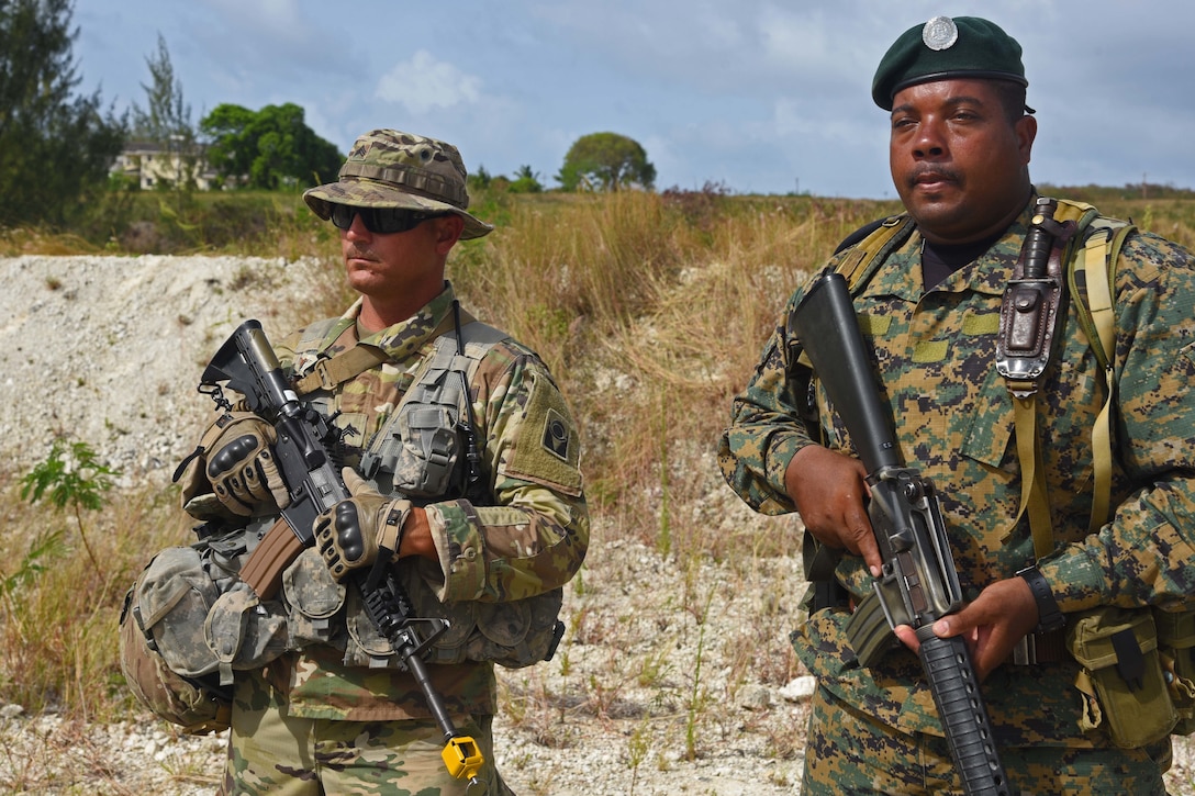 Florida National Guard Sgt. Randall Green stands guard with a member of the Barbados Defence Force during defensive position training during Tradewinds 2017 in Barbados, June 8. Military and civilians from over 20 countries are participating in this year’s exercise in Barbados and Trinidad & Tobago, which runs from June 6-17, 2017. (US Army National Guard Photo by Sgt. Garrett L. Dipuma)