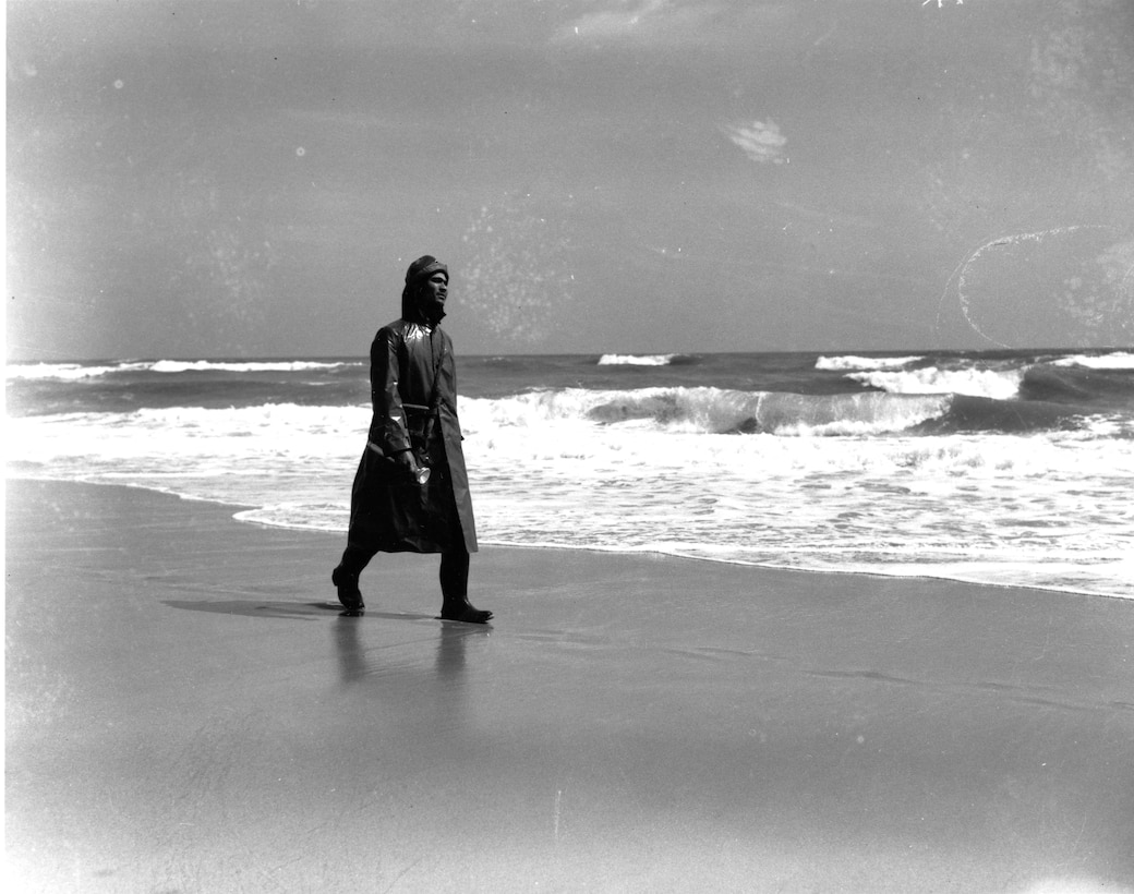 Station Pea Island, North Carolina
USLSS Station #17, Sixth District
 Coast Guard Station #177
Surfman Ruben Gallop, USCG  
Surfman Ruben Gallop patrols the beach at the Pea Island Lifeboat Station during World War II.  Note the flashlight he is carrying for signaling.
No photo number/date; probably 1942.





