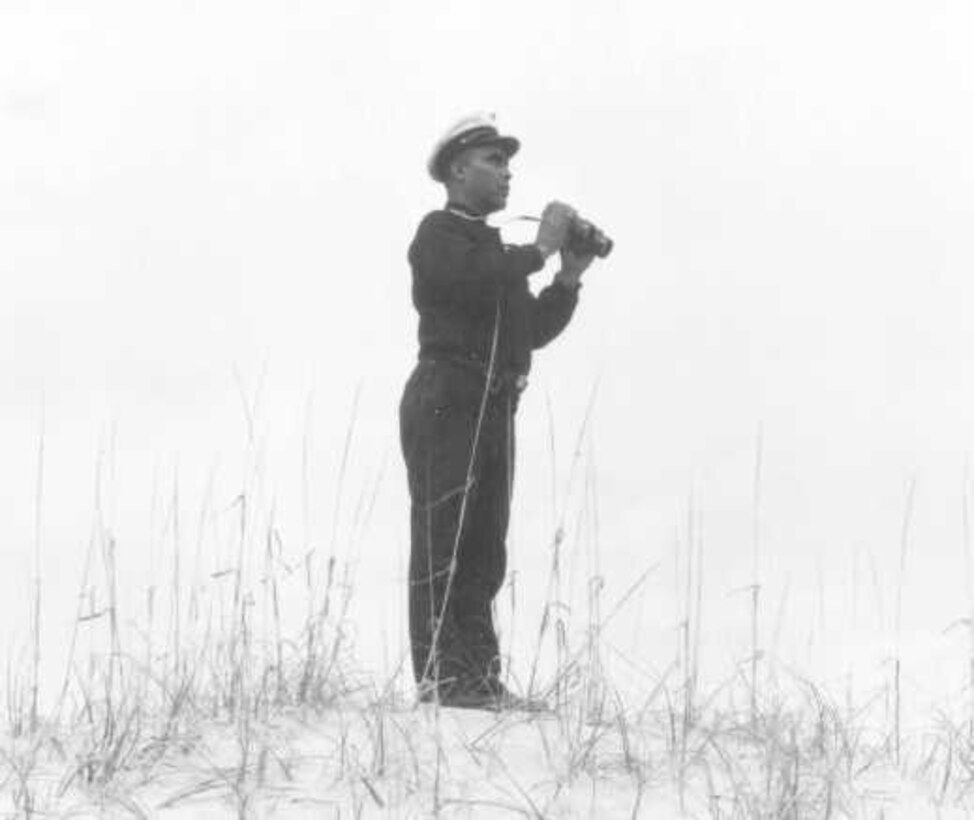 Station Pea Island, North Carolina
USLSS Station #17, Sixth District
Coast Guard Station #177
Petty Officer First Class Maxie Berry, Sr., USCG  
BM1c Maxie Berry, Sr., Officer in Charge of the historic Pea Island Station, scans the seas near the Pea Island Station in the early 1940's.
No photo number/date; probably 1942.







