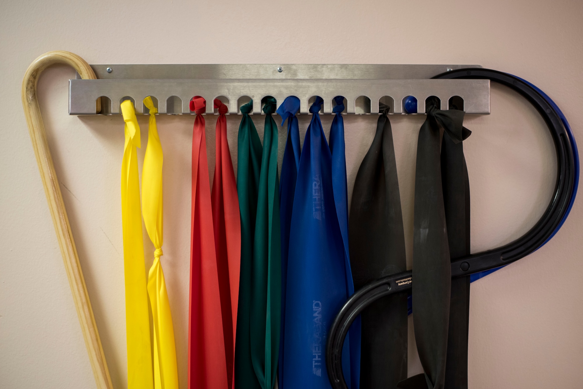 Elastic resistance bands hang on the wall of the 27th Special Operations Medical Group Physical Medicine Office April 26, 2017, at Cannon Air Force Base, NM. The different color bands have different resistances and patients can utilize the bands to increase the strength of the muscles in their arms or legs. (U.S. Air Force photo by Staff Sgt. Michael Washburn/Released)