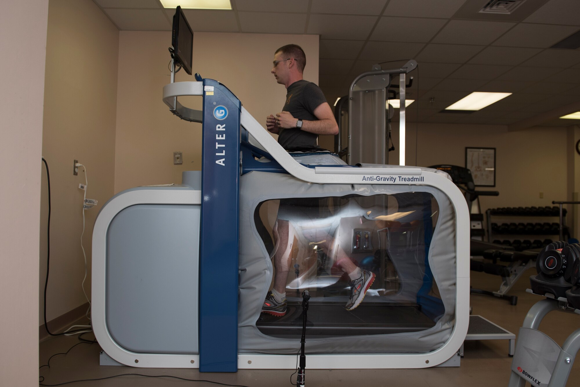Michael Chitwood, physical therapy patient, runs on an anti-gravity treadmill at the 27th Special Operations Medical Group Physical Medicine Office April 26, 2017, at Cannon Air Force Base, NM. An anti-gravity treadmill allows the patient to run at a percentage of their bodyweight and adjust that percentage over time as they get stronger. (U.S. Air Force photo by Staff Sgt. Michael Washburn/Released)