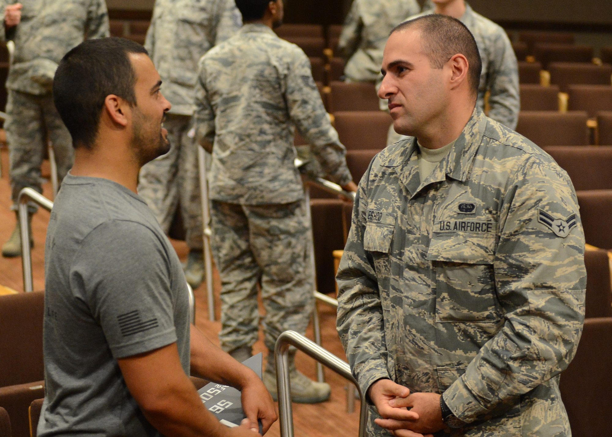 Former Navy SEAL Chad Williams, talks with Airman 1st Class Makarios Eshoo, 56th Communications Squadron network infrastructure technician, after his speech June 7, 2017, at Luke Air Force Base, Ariz. Williams had the opportunity to speak with Airmen about his time as a Navy SEAL and held a question and answer session afterward. (U.S. Air Force photo by Senior Airman James Hensley)