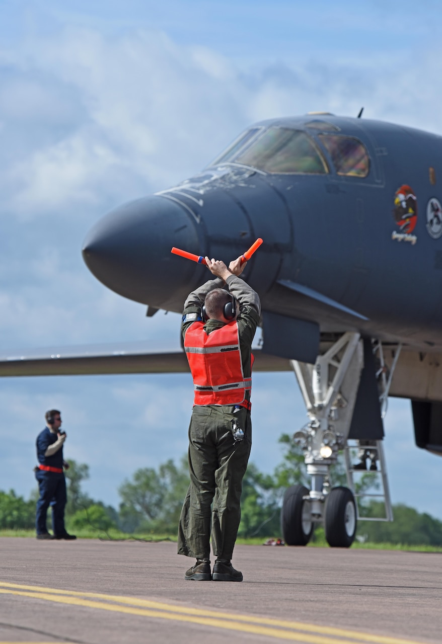 U.S. Air Force Airman 1st Class Jacob Feeback, 28th Aircraft Maintenance Squadron crew chief, marshals a B-1B Lancer assigned to Ellsworth Air Force Base, S.D. at RAF Fairford, U.K., June 7, 2017. Bomber missions in the European theatre enable crews to maintain a high state of readiness and proficiency, and validate the Air Force’s always-ready global strike capability. (U.S. Air Force photo by Tech. Sgt. Miguel Lara III)