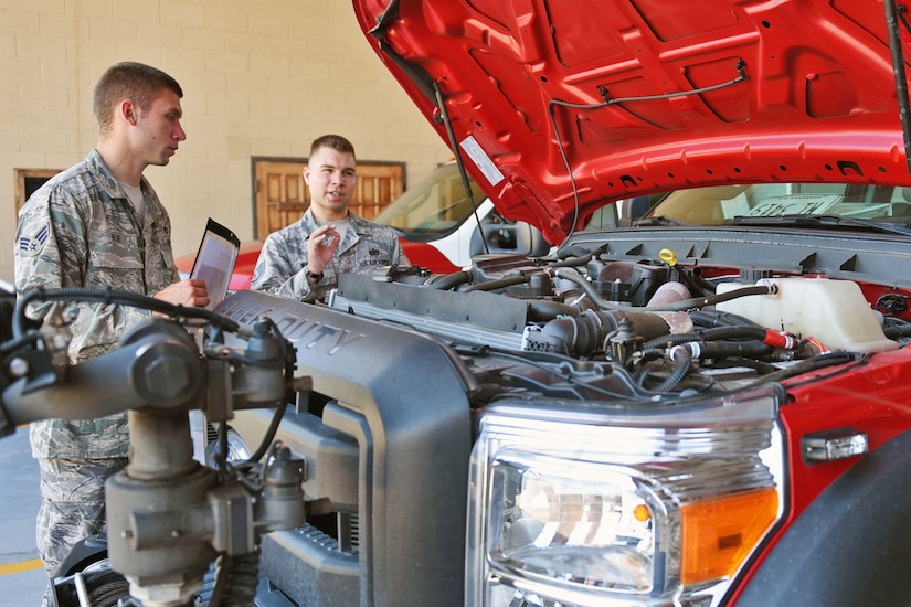 U.S. Air Force Staff Sergeant Zachary White (right), 612th Air Base Squadron, Fire Emergency Services crew chief, shows Senior Airman Eli Blue (left) how to properly check the Fire Department vehicles at Soto Cano Air Base, May 25th, 2017. Staff Sgt. White works as a Fire crew chief at Joint Task Force-Bravo’s Fire Emergency Services and strives to make his team progress professionally and perform their jobs as best they can.  (U.S. Army photo by Maria Pinel)