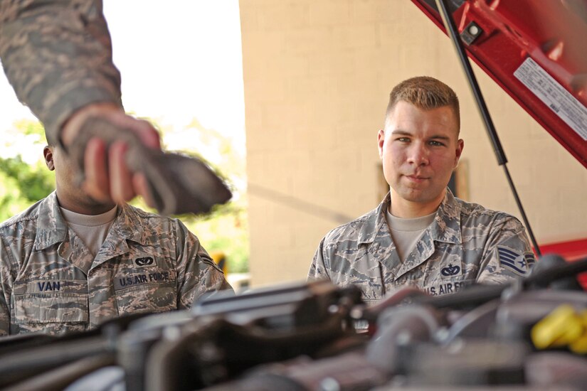 U.S. Air Force Staff Sergeant Zachary White (right), 612th Air Base Squadron, Fire Emergency Services crew chief, shows two of his crew members how to properly check the Fire Department vehicles at Soto Cano Air Base, May 25th, 2017. Staff Sgt. White works as a Fire crew chief at Joint Task Force-Bravo’s Fire Emergency Services and strives to make his team progress professionally and perform their jobs the as best they can.  (U.S. Army photo by Maria Pinel)