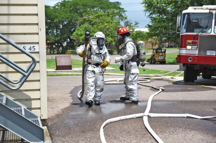 U.S. Air Force Staff Sergeant Zachary White (right), 612th Air Base Squadron, provides guidance for a fellow Airman during a simulated call to action exercise in response to a fire emergency at Soto Cano Air Base, May 25th, 2017. Striving to maintain readiness among his team, he constantly teaches them the proper procedures to prepare and respond to an emergency situation.  (U.S. Army photo by Maria Pinel)