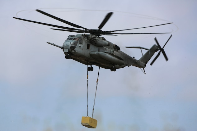A CH-53E Super Stallion carries a 20,000 pound training load during external lift training at Marine Corps Base Camp Pendleton, California, June 5. Helicopter Support Team (HST) Marines with Combat Logistics Battalion (CLB) 5 supported Marine Heavy Helicopter Squadron (HMH) 466 during the external lift exercise, securing the training load to the CH-53E ensuring the aircraft carried the load safely.