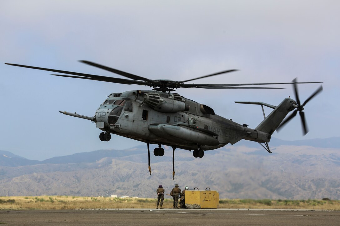 Helicopter Support Team (HST) Marines with Combat Logistics Battalion (CLB) 5 prepare to attach a 20,000 pound training load to a CH-53E Super Stallion during external lifts training at Marine Corps Base Camp Pendleton, California, June 5. The HST Marines with CLB-5 supported Marine Heavy Helicopter Squadron (HMH) 466 during the external lift exercise, securing the training load to the CH-53E ensuring the aircraft carried the load safely. 