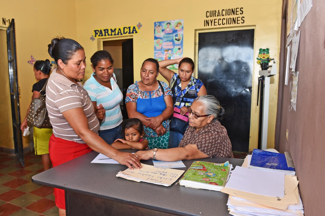 Maria Cruz, a local nurse, signs in patients prior to receiving care from a team of Joint Task Force-Bravo's Medical Element, at the Regional Health Center in the Tepanguare village located in La Paz, Honduras, May 24, 2017. The team of three participated in a monthly visit to the clinic where they provide free consultations and medications to the local population from Tepanguare and neighboring communities. 
