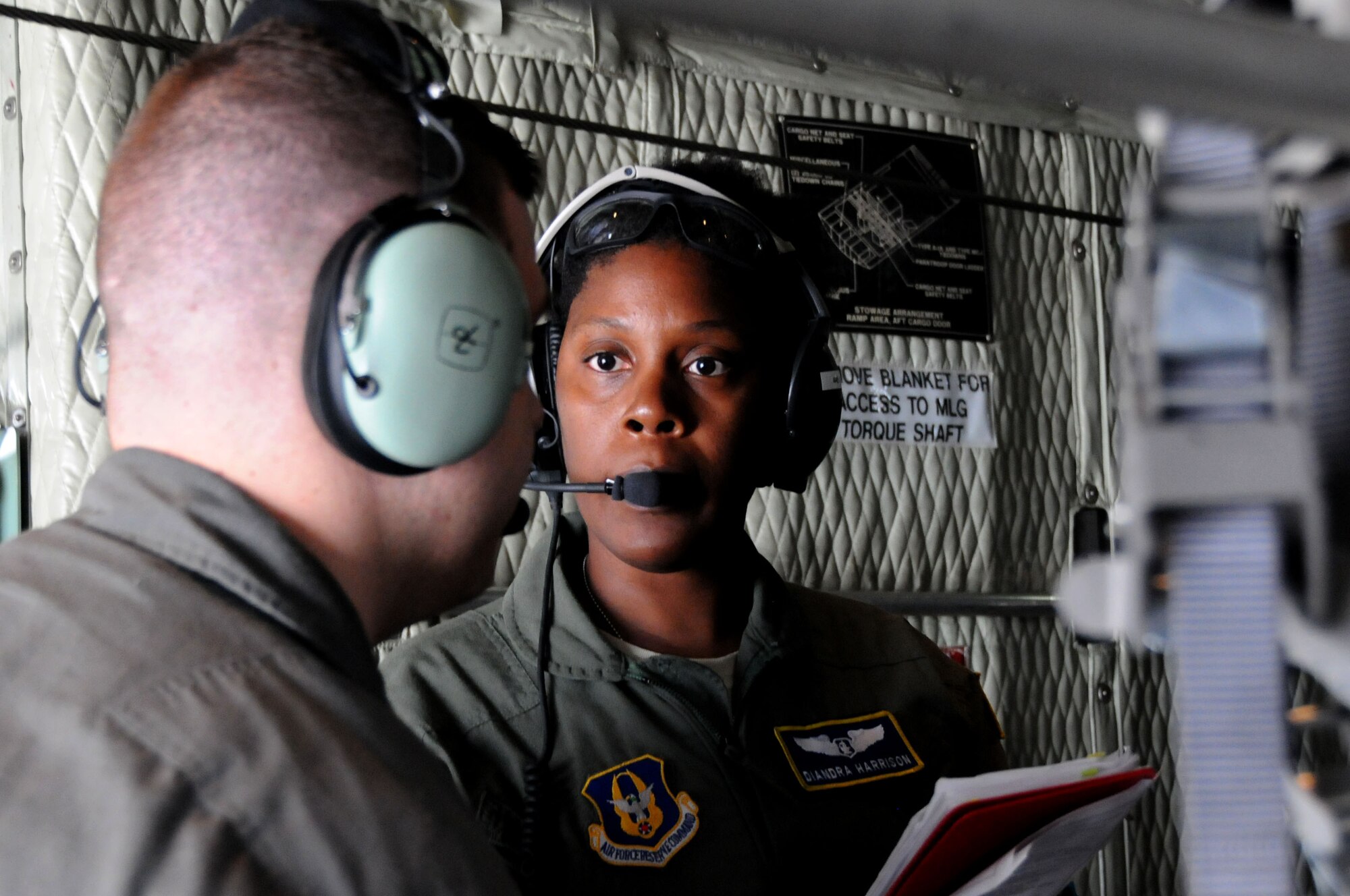 Capt. Diandra Harrison, a flight nurse with the 445th Aeromedical Evacuation Squadron here, communicates with a fellow Citizen Airman during a joint training mission here, June 7, 2017. The 445th AES trained for two hours while airborne to simulate a real-world scenario. (U.S. Air Force photo/Senior Airman Joshua Kincaid)
