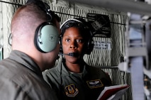 Capt. Diandra Harrison, a flight nurse with the 445th Aeromedical Evacuation Squadron here, communicates with a fellow Citizen Airman during a joint training mission here, June 7, 2017. The 445th AES trained for two hours while airborne to simulate a real-world scenario. (U.S. Air Force photo/Senior Airman Joshua Kincaid)