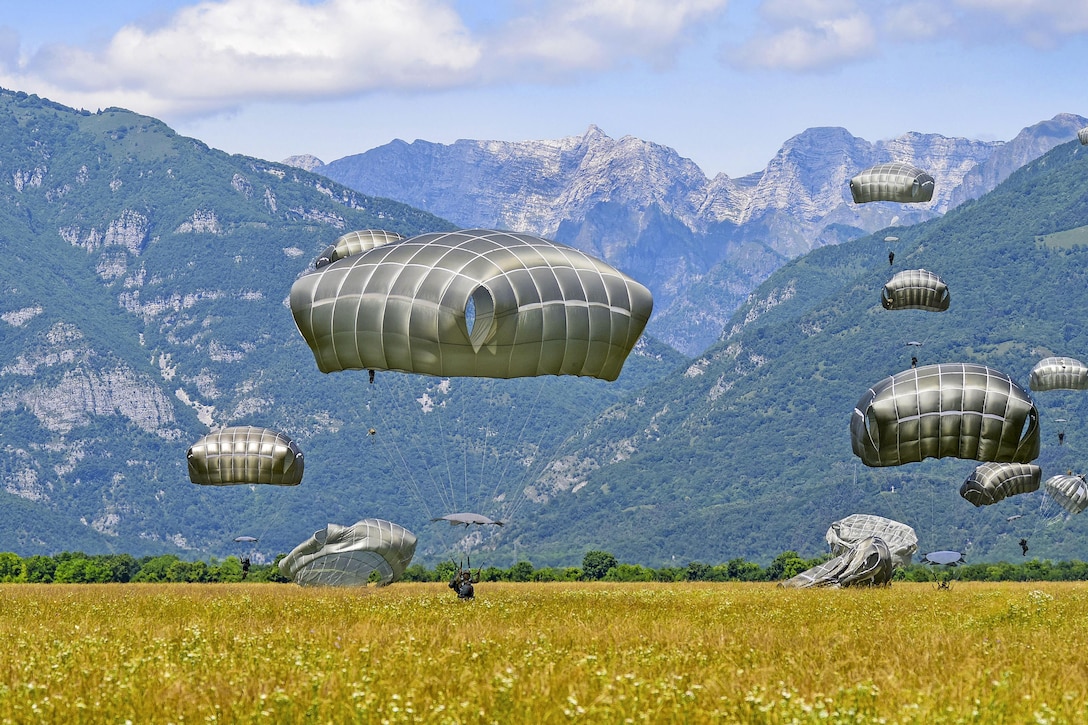 Army paratroopers descend on Juliet drop zone in Pordenone, Italy, June 8, 2017, after jumping from an Air Force C-130 Hercules during airborne operations. The paratroopers are assigned to the 2nd Battalion, 503rd Infantry Regiment. Army photo by Davide Dalla Massara
