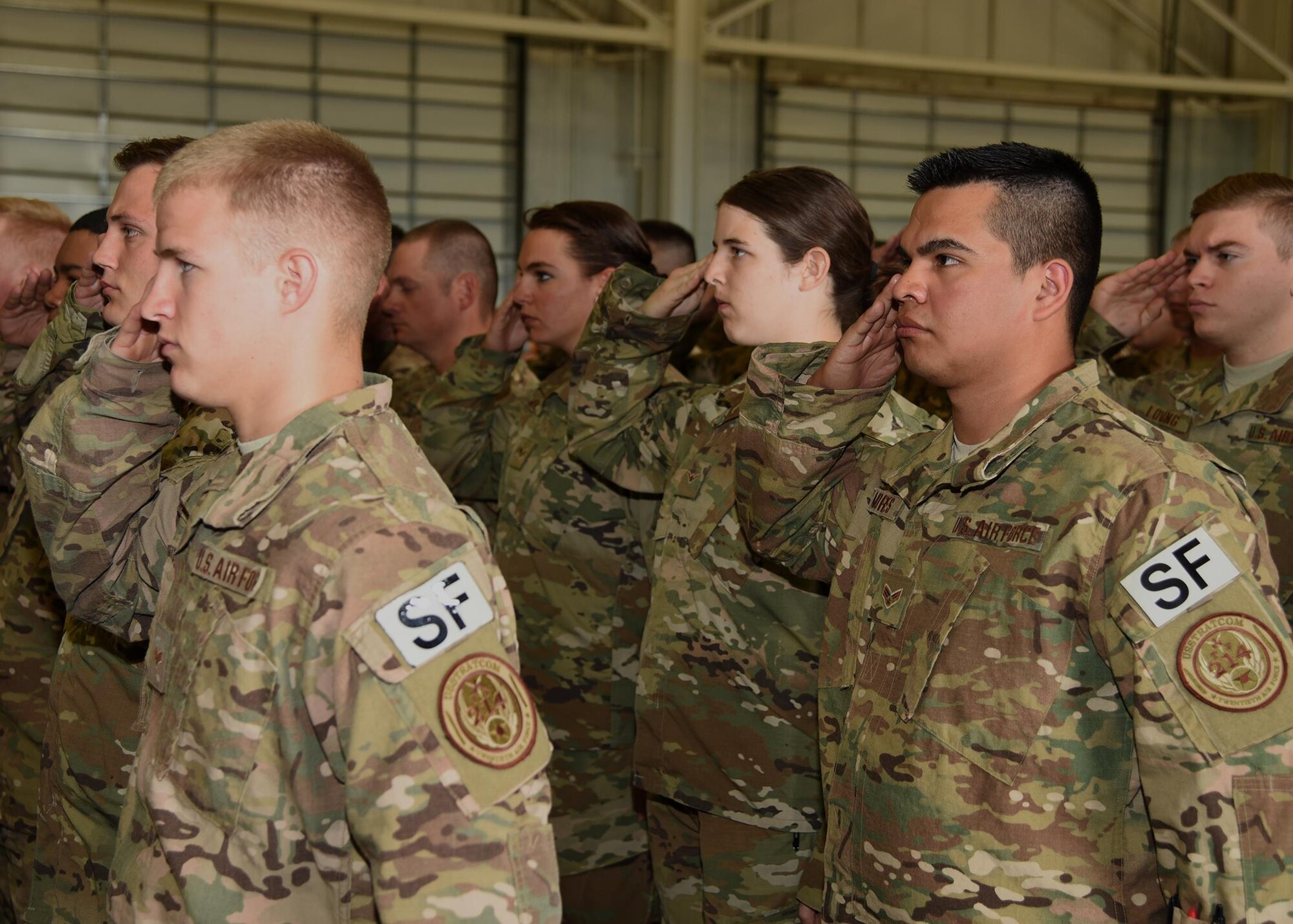 Defenders in the 90th Security Forces Group render a salute to Col. John Grimm, their commander, at the 90th SFG Change of Command in the Peacekeeper High Bay on F.E. Warren Air Force Base, Wyo., June 9, 2017. Grimm assumed command of the group during the ceremony which represents a formal transition of authority from the outgoing commanding to the incoming commander. (U.S. Air Force photo by Glenn S. Robertson)
