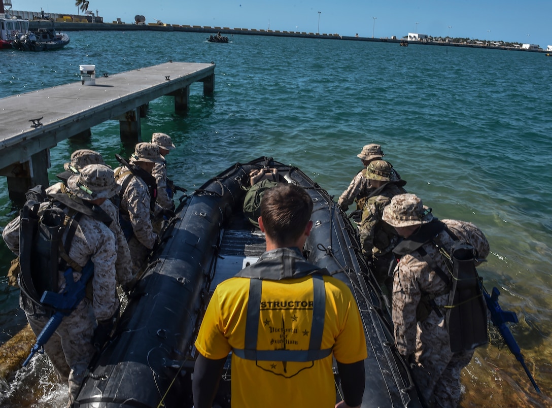 U.S. Marines and Airmen carry a Zodiac boat to the water during Marine Special Operations School’s Individual Training Course, March 22, 2017, at Key West, Fla. For the first time, U.S. Air Force Special Tactics Airmen spent three months in Marine Special Operations Command’s initial Marine Raider training pipeline, representing efforts to build joint mindsets across special operations forces.  (U.S. Air Force photo by Senior Airman Ryan Conroy)