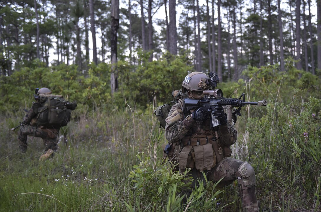 A U.S. Air Force Special Tactics officer with the 24th Special Operations Wing provides rear security during a troop movement at Field Training Exercise Raider Spirit, May 1, 2017, at Camp Lejeune, N.C. For the first time, Special Tactics Airmen spent three months in Marine Special Operations Command’s initial Marine Raider training pipeline, representing efforts to build joint mindsets across special operations forces.  (U.S. Air Force photo by Senior Airman Ryan Conroy)