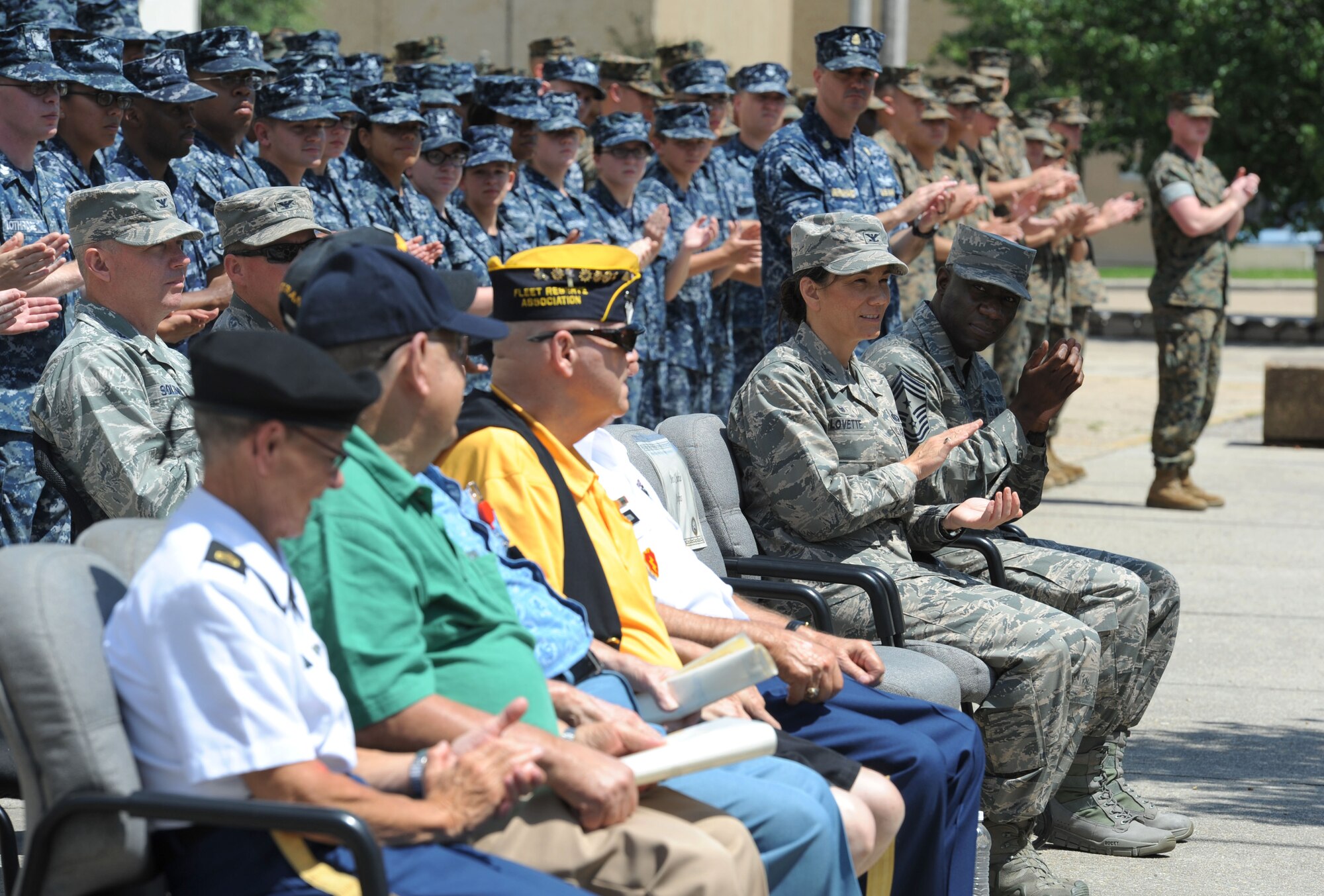 Keesler leadership, Sailors and Marines applaud for veterans from the Armed Forces Retirement Home in Gulfport, Miss., during the Battle of Midway Commemoration Ceremony hosted by the Center for Naval Aviation Technical Training Unit Keesler June 7, 2017, on Keesler Air Force Base, Miss. The ceremony commemorated the 75th anniversary of the Battle of Midway, which was a U.S. naval victory during World War II. (U.S. Air force photo by Kemberly Groue)