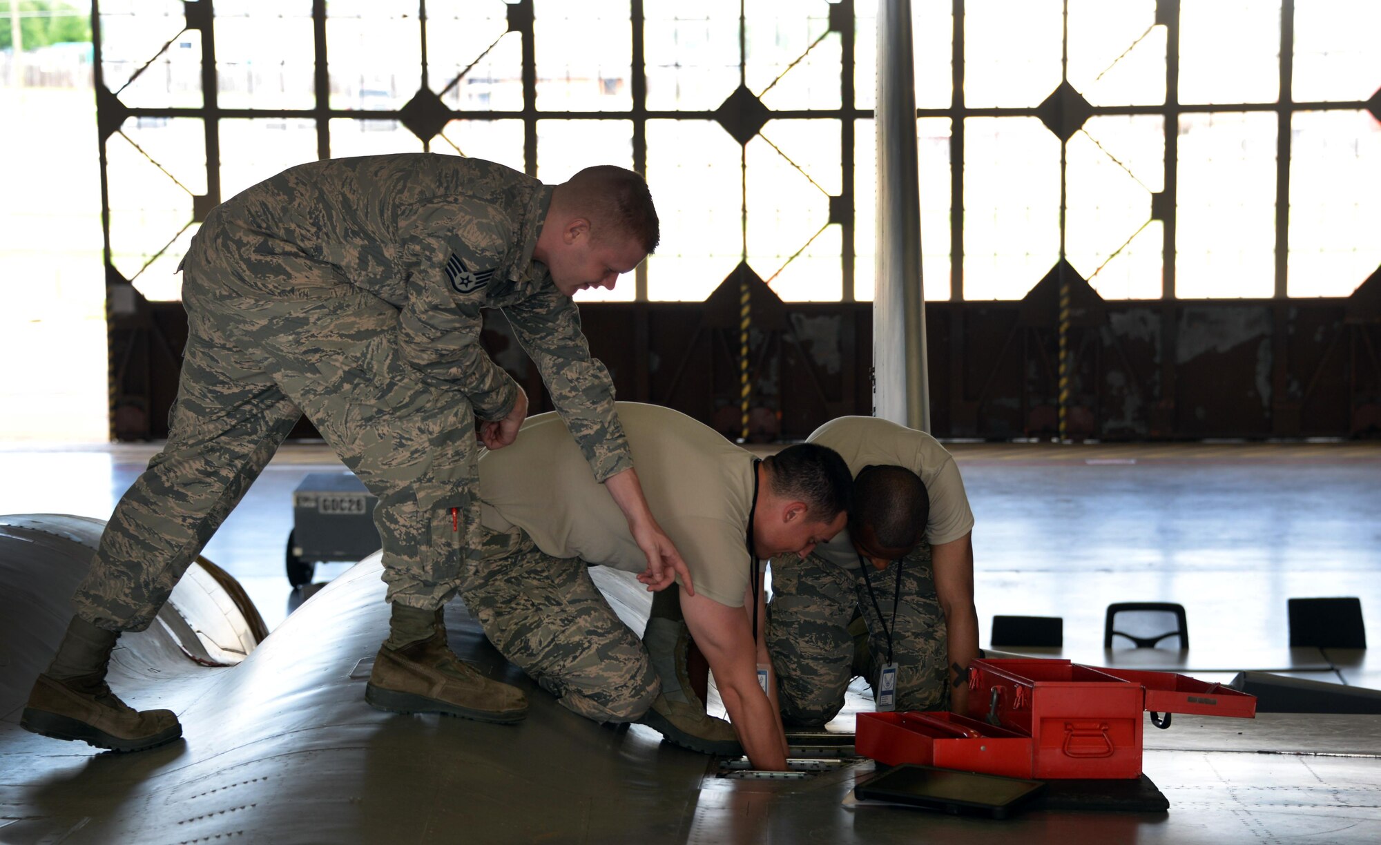 Staff Sgt. Dawson Parker, 364th Training Squadron electrical and environmental systems apprentice course instructor, directs his students, Airmen Trenton Jackson and Tyler Bethone, on how to replace the bleed air check valve at Sheppard Air Force base, Texas. The valve prevents shutdown of the environmental control system, which if shut down would result in loss of the anti-G system that prevents the pilot from passing out due to the severe effects of G-force. (U.S. Air Force photo by Senior Airman Robert L. McIlrath)