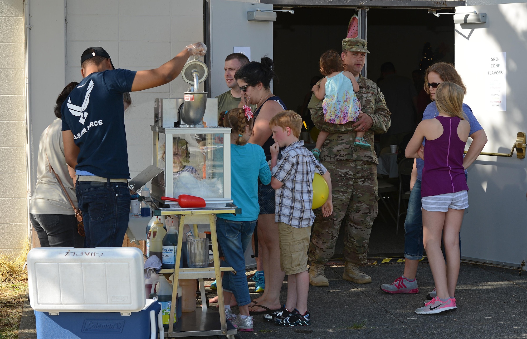 Volunteers from the 627th Logistics Readiness Squadron make snow cones for Airmen and their families at the Hearts Apart dinner June 6, 2017, at Joint Base Lewis-McChord, Wash. The night was Hawaiian-themed, and more than 30 Airmen and their families were provided a free, catered meal served by leadership. (U. S. Air Force photo/Senior Airman Jacob Jimenez)     
 
