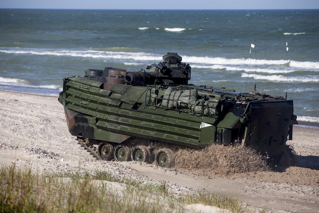 VENTSPILS, Latvia - Marines with 2nd Assault Amphibian Battalion, 2nd Marine Division, II Marine Expeditionary Force, transfer Marines with Bravo Company, 1st Battalion, 23rd Marine Regiment, 4th Marine Division and 4th Air Naval Gunfire Liaison Company, Force Headquarters Group, Marine Forces Reserve, to the shores of Ventspils, Latvia, for a beach-assault training operation during Exercise Saber Strike 17, June 6, 2017. The beach landings took place concurrently between exercise Saber Strike and Baltic Operations. Exercise Saber Strike 17 is an annual combined-joint exercise conducted at various locations throughout the Baltic region and Poland. The combined training prepares NATO Allies and partners to effectively respond to regional crises and to meet their own security needs by strengthening their borders and countering threats. (U.S. Marine Corps photo by Lance Cpl. Ricardo Davila/Released)