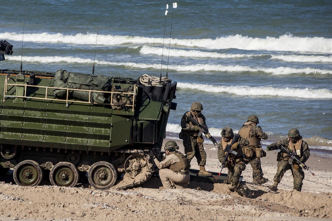 VENTSPILS, Latvia - Marines with 2nd Assault Amphibian Battalion, 2nd Marine Division, II Marine Expeditionary Force, transfer Marines with Bravo Company, 1st Battalion, 23rd Marine Regiment, 4th Marine Division and 4th Air Naval Gunfire Liaison Company, Force Headquarters Group, Marine Forces Reserve, to the shores of Ventspils, Latvia, for a beach-assault training operation during Exercise Saber Strike 17, June 6, 2017. The beach landings took place concurrently between exercise Saber Strike and Baltic Operations. Exercise Saber Strike 17 is an annual combined-joint exercise conducted at various locations throughout the Baltic region and Poland. The combined training prepares NATO Allies and partners to effectively respond to regional crises and to meet their own security needs by strengthening their borders and countering threats. (U.S. Marine Corps photo by Lance Cpl. Ricardo Davila/Released)