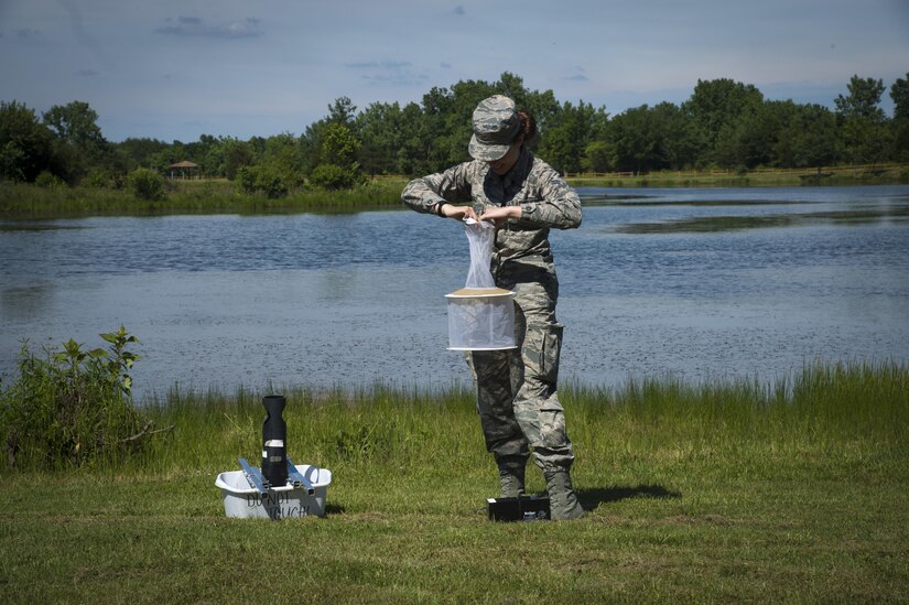 Airman 1st Class Samantha Yordy, 779th Medical Group public health technician, sets mosquito traps at the base lake on Joint Base Andrews, Md., June 8, 2017. Airmen from public health set traps about twice a week. (U.S. Air Force photo by Senior Airman Mariah Haddenham)