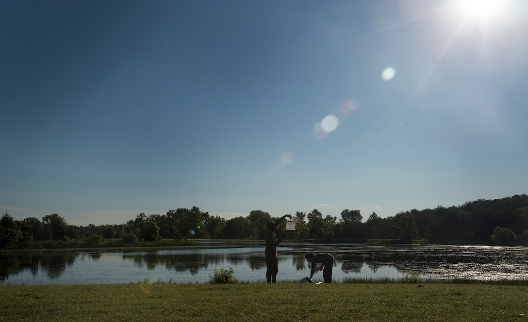 Airmen from the 779th Medical Group public health flight collect mosquito traps at the base lake on Joint Base Andrews, Md., June 8, 2017. Airmen from public health set traps about twice a week. (U.S. Air Force photo by Senior Airman Mariah Haddenham)