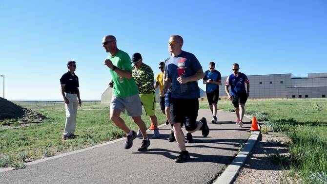 Participants run down the path during the first 1-mile portion of the 13th annual Schriever duathlon at Schriever Air Force Base, Colorado, Friday, June 9, 2017. The event required athletes to complete a 1-mile run, followed by a 12-mile bike ride and finish with another 1-mile run. (U.S. Air Force photo/Senior Airman Arielle Vasquez)