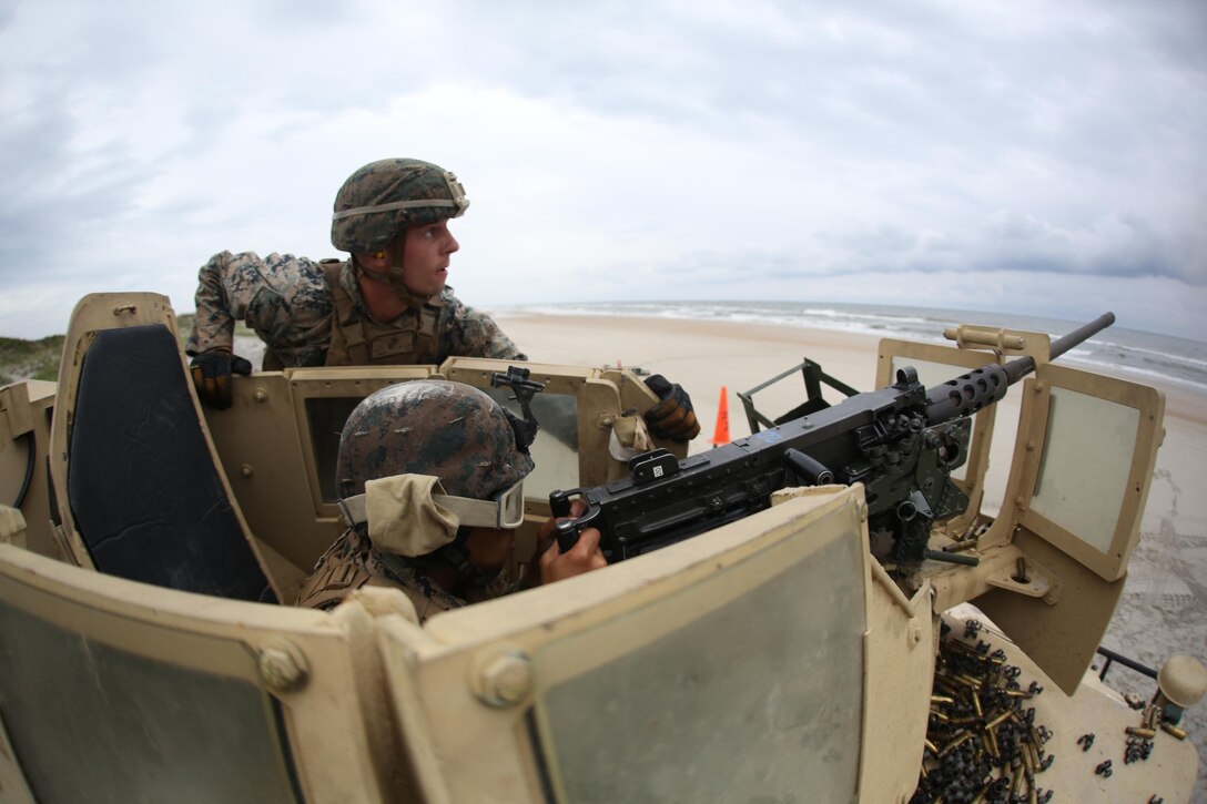 Cpl. Blake Cannon, top, supervises Lance Cpl. Sergio Torresbatres, firing an M2 .50 caliber heavy machine gun at a type 1 drone at Marine Corps Base Camp Lejeune, N.C., June 7, 2017. Cannon is a team leader assigned to 1st platoon of B Battery, 2nd Low Altitude Air Defense Battallion, Marine Air Control Group 28, and takes on the responsibilty of training the Marines in his team to the highest standards. Torresbatres is an electrician with Marine Wing Support Squadron 274, Marine Aircraft Group 29, 2nd MAW. (U.S. Marine Corps photo by Pfc. Skyler Pumphret/ Released)