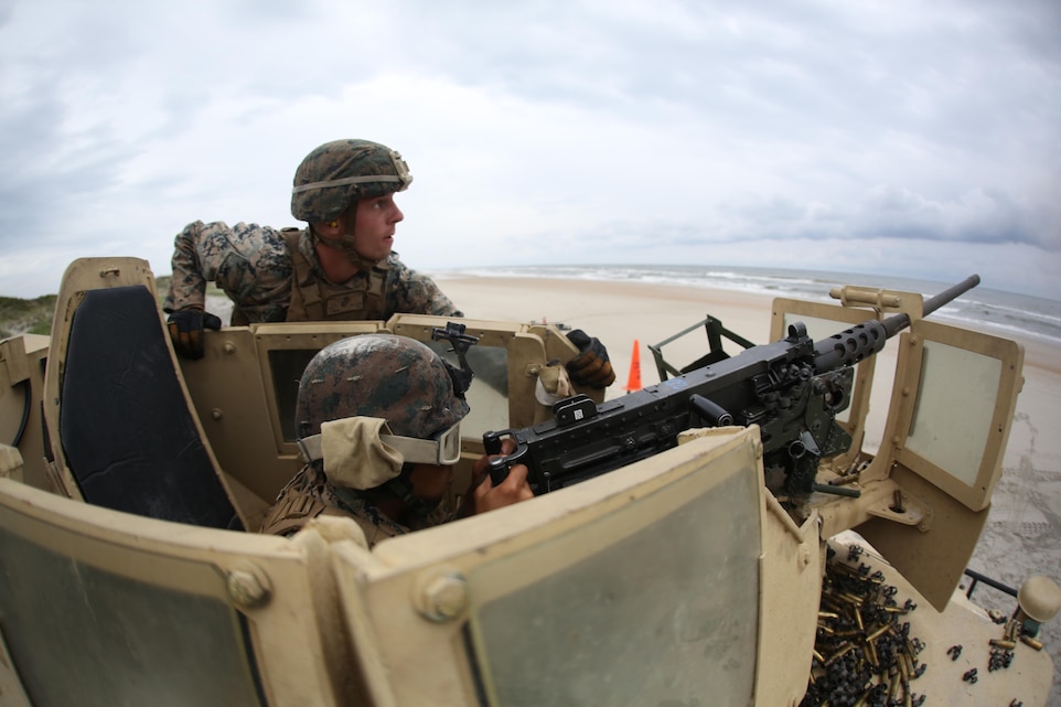 Cpl. Blake Cannon, top, supervises Lance Cpl. Sergio Torresbatres, firing an M2 .50 caliber heavy machine gun at a type 1 drone at Marine Corps Base Camp Lejeune, N.C., June 7, 2017. Cannon is a team leader assigned to 1st platoon of B Battery, 2nd Low Altitude Air Defense Battallion, Marine Air Control Group 28, and takes on the responsibilty of training the Marines in his team to the highest standards. Torresbatres is an electrician with Marine Wing Support Squadron 274, Marine Aircraft Group 29, 2nd MAW. (U.S. Marine Corps photo by Pfc. Skyler Pumphret/ Released)