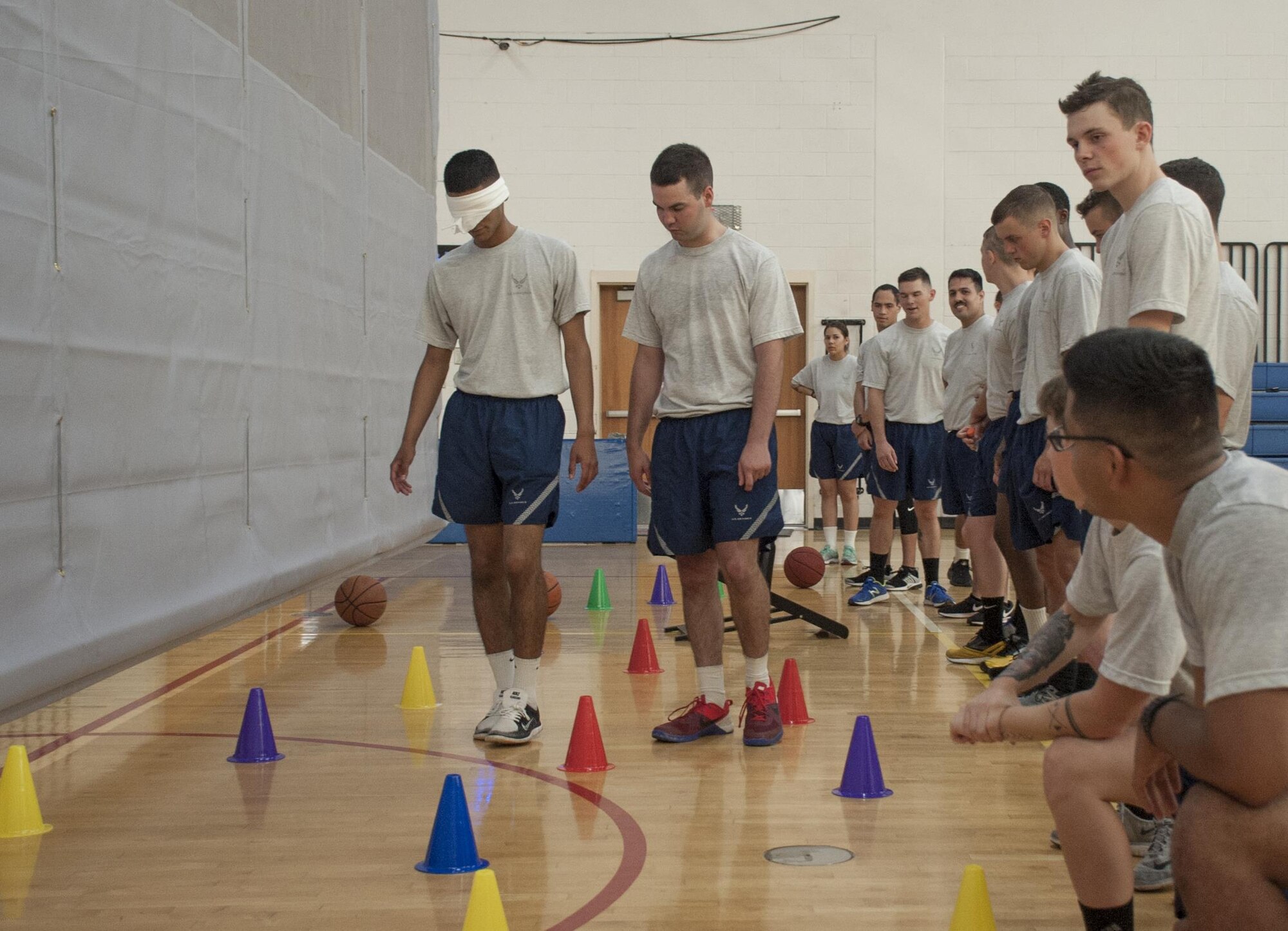 An Airman works his way through a course while relying on his fellow wingman at MacDill Air Force Base, Fla., June 9, 2017. During the new First Term Airmen’s Course, also known as Airmanship 300, Airmen participate in interactive activities teaching them leadership, followership and other Air Force values. (U.S. Air Force photo by Airman 1st Class Mariette Adams)