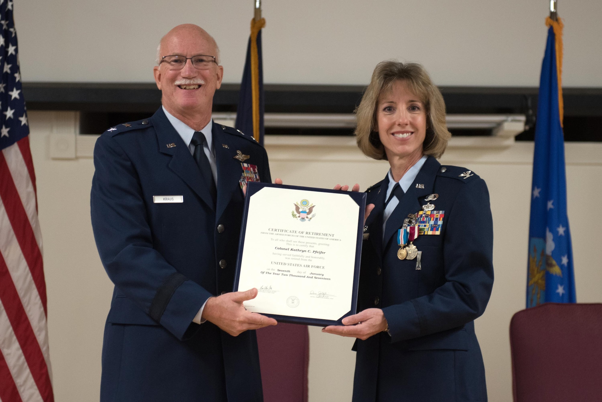 Col. Kathryn Pfeifer (right), outgoing commander of the 123rd Mission Support Group, receives her Certificate of Retirement from retired Maj. Gen. Mark Kraus, former Air National Guard assistant to the commander, United States Air Forces Central and a former assistant adjutant general for Air, Kentucky National Guard, during a ceremony held in Pfeifer’s honor at the Kentucky Air National Guard Base in Louisville, Ky., Jan. 7, 2017. Pfeifer is retiring after more than 28 years of service. (U.S. Air National Guard photo by Staff Sgt. Joshua Horton)