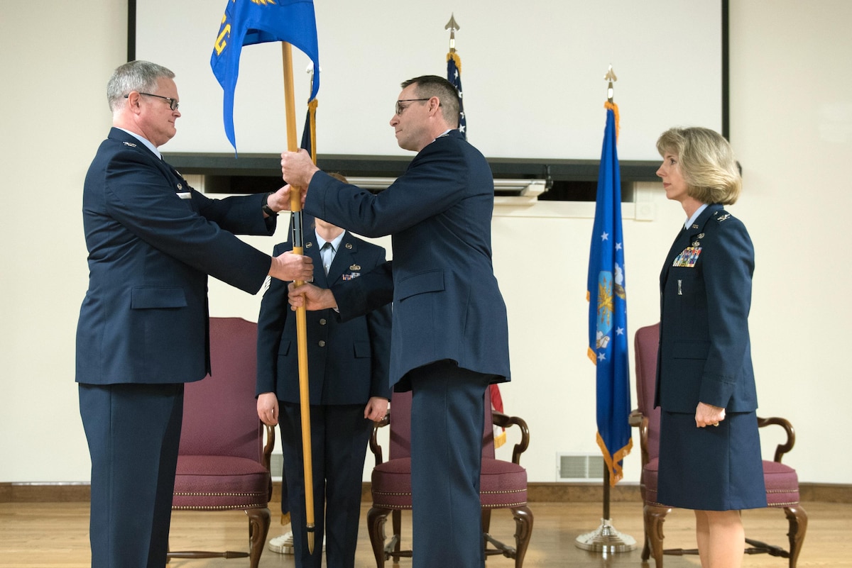 Lt. Col. Patrick Pritchard (center) assumes command of the 123rd Mission Support Group as he accepts the unit’s guidon from Col. David Mounkes (left), commander of the 123rd Airlift Wing, during a change-of-command ceremony held at the Kentucky Air National Guard base in Louisville, Ky., Jan. 7, 2017. Pritchard replaces Col. Kathryn Pfeifer (right), who retired after more than 28 years of service. (U.S. Air National Guard photo by Staff Sgt. Joshua Horton)