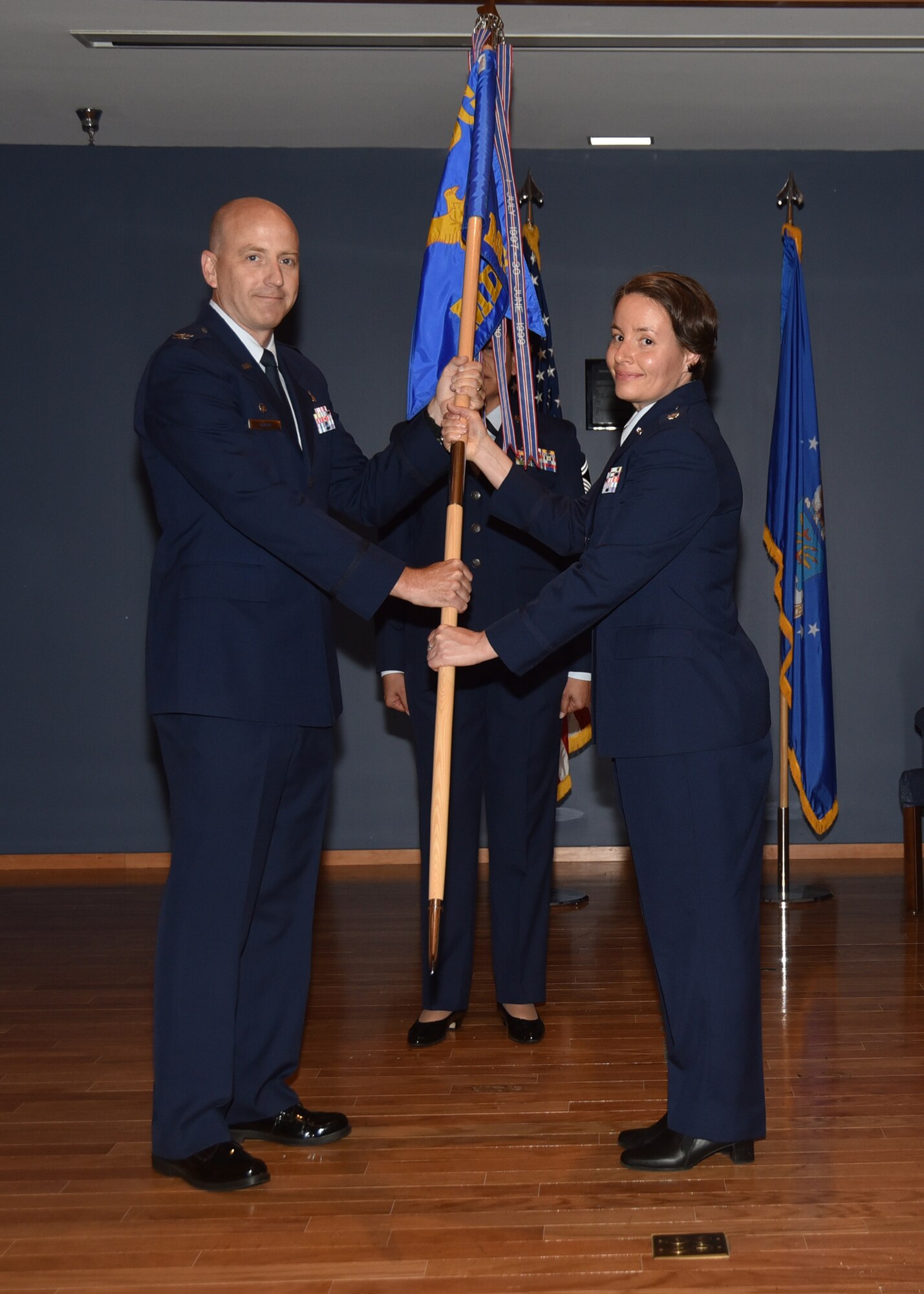 U.S. Air Force Col. Scott McKim, 325th Medical Group commander (left), presents the 325th Medical Support Squadron guidon to the new commander, Lt. Col. Joanna Rentes, during the 325th MDSS change of command ceremony at Tyndall Air Force Base, Fla., June 7, 2017. The 325th MDSS was activated in September 1994. Their mission is to support medical and dental care for 29,000 beneficiaries while enabling all wing and associate units to maximize wartime readiness and combat capability. (U.S. Air Force photo by Senior Airman Sergio A. Gamboa/Released) 