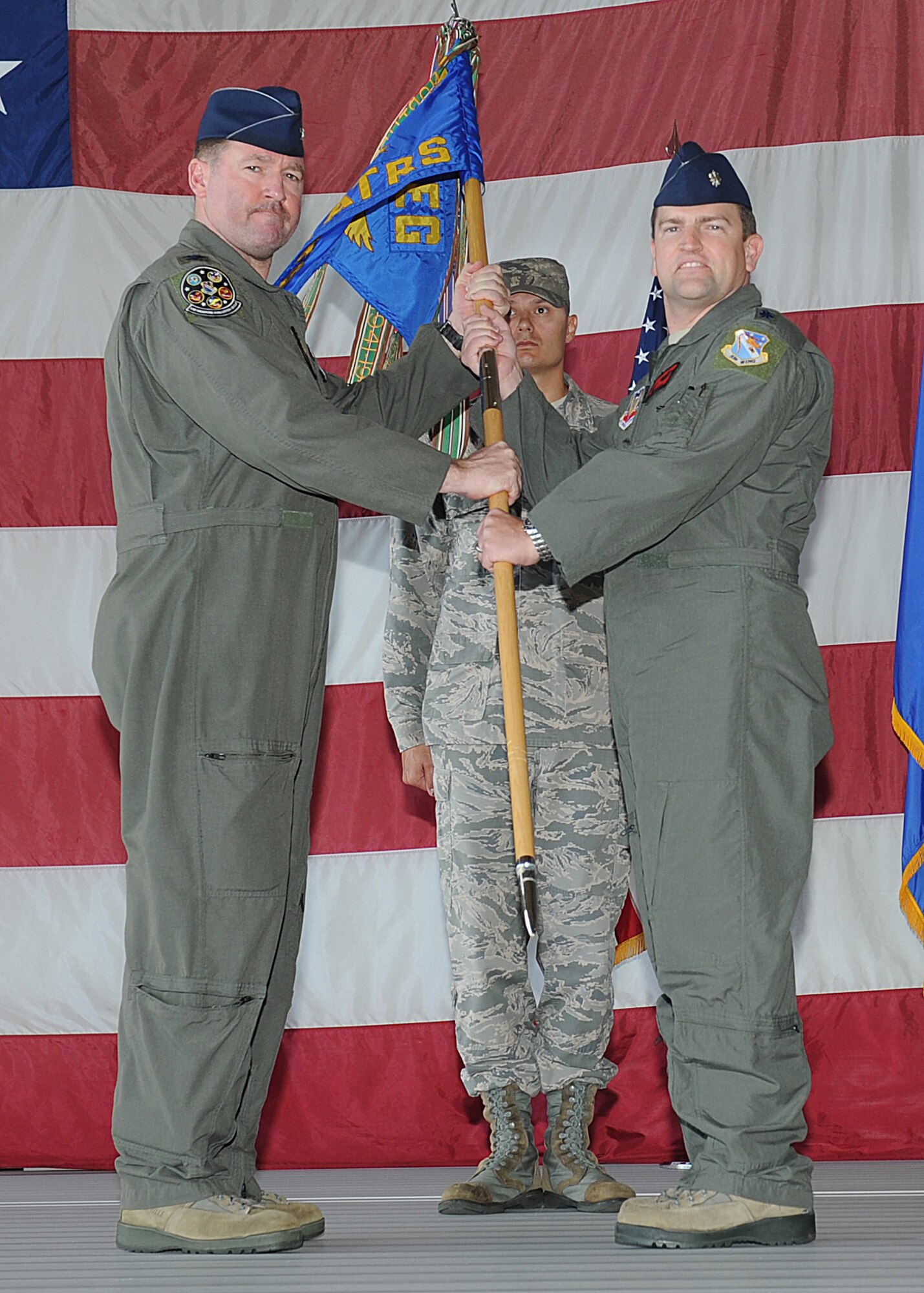 U.S. Air Force Col. Lance A. Wilkins, 53rd Weapons Evaluation Group commander (left), passes the ceremonial guidon to the new commander, Lt. Col. Ryan D. Serril (right), during the 82nd Aerial Targets Squadron change of command ceremony at Tyndall Air Force Base, Fla., June 9, 2017. The mission of the 82nd Aerial Targets Squadron is to provide safe, effective, and efficient aerial target support for Department of Defense sponsored weapons tests and evaluations programs. (U.S. Air Force photo by Airman 1st Class Delaney Rose/Released) 