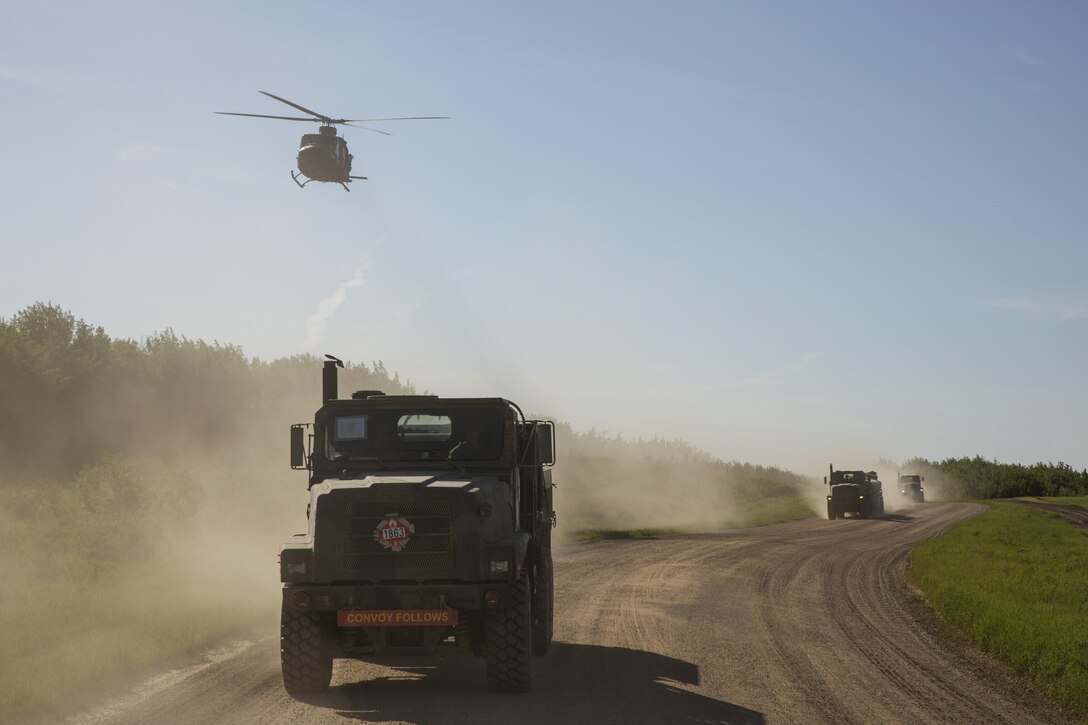 Marines assigned to Marine Wing Support Squadron 473, 4th Marine Aircraft Wing, Marine Forces Reserve, convoy to the Canadian Manoeuvre Training Centre, Camp Wainwright accompanied by two Royal Canadian Air Force Bell CH-146 Griffons in Alberta, Canada, May 30, 2017, during exercise Maple Flag 50. MWSS-473 convoyed to the training center to provide real world refueling support to Royal Canadian Air Force CH-147 Chinook and CH-146 Griffon type model series during exercise Maple Flag 50. (U.S. Marine Corps Photo by Lance Cpl. Niles Lee)