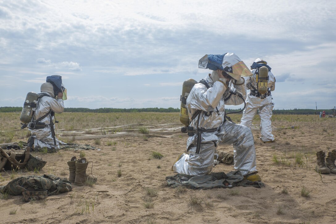 Crash Fire Rescue Marines with Marine Wing Support Squadron 473, 4th Marine Aircraft Wing, Marine Forces Reserve, practice putting on their protective equipment during a simulated fire drill at Canadian Forces Base Cold Lake during exercise Maple Flag, June 1, 2017. Three geographically separate MWSS-473 detachments came together to participate in exercise Maple Flag May 29-June 23, 2017, during their annual training. (U.S. Marine Corps photo by Lance Cpl. Niles Lee/Released)
