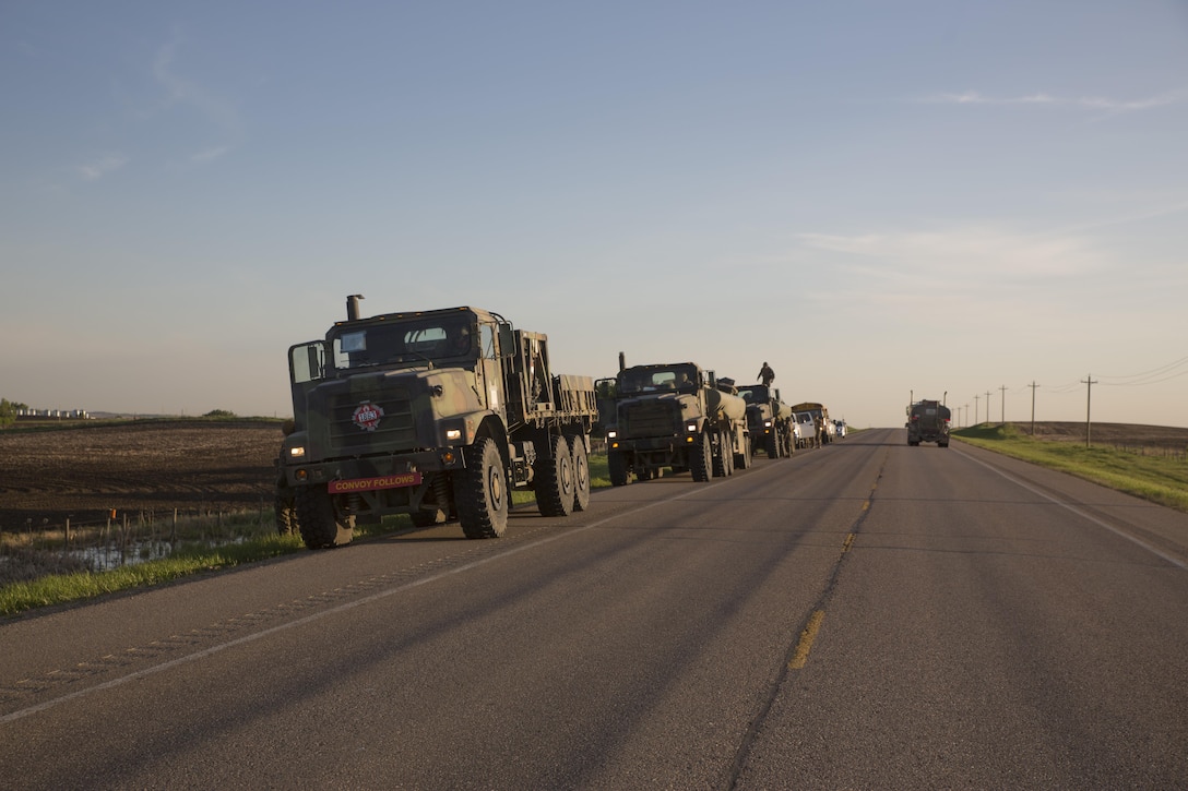 Marines assigned to Marine Wing Support Squadron 473, 4th Marine Aircraft Wing, Marine Forces Reserve, pause at a checkpoint during a convoy to the Canadian Manoeuvre Training Centre, Camp Wainwright in Alberta, Canada, March 30, 2017, during exercise Maple Flag 50. MWSS-473 convoyed to the training center to provide real world refueling support to Royal Canadian Air Force CH-147 Chinook and CH-146 Griffon type model series during exercise Maple Flag 50. (U.S. Marine Corps Photo by Lance Cpl. Niles Lee)