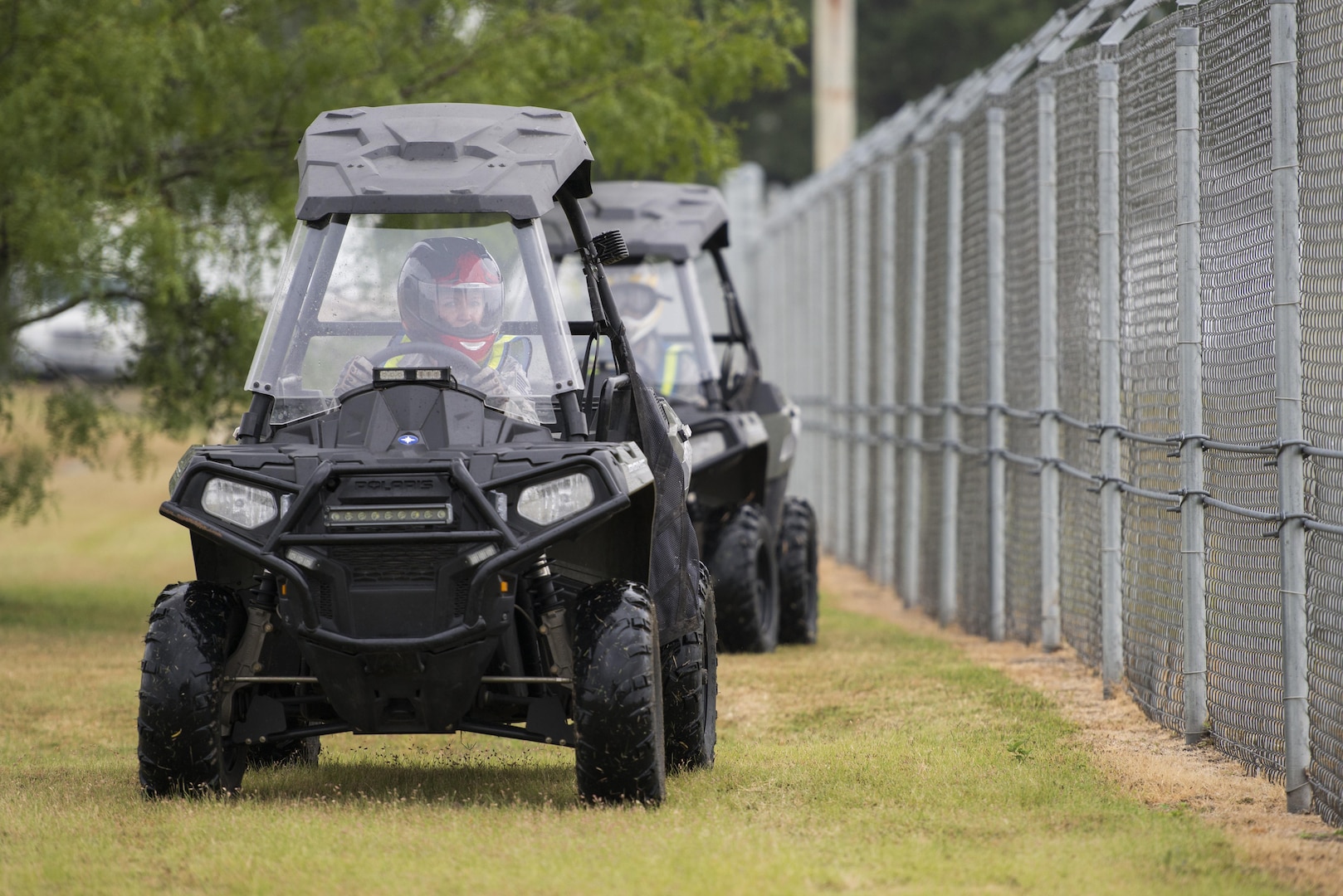 Technical Sgt. Michelle Aberle, 802nd Security Forces Squadron installation security, and Technical Sgt. Paul Turner, 802nd Security Forces Squadron installation security, drive along the base fence line during a security check May 9, 2017, at Joint Base San Antonio-Lackland, Texas.  Aberle and Turner provide force protection for base personnel, equipment and facilities from threats to include intrusion by unauthorized people. 