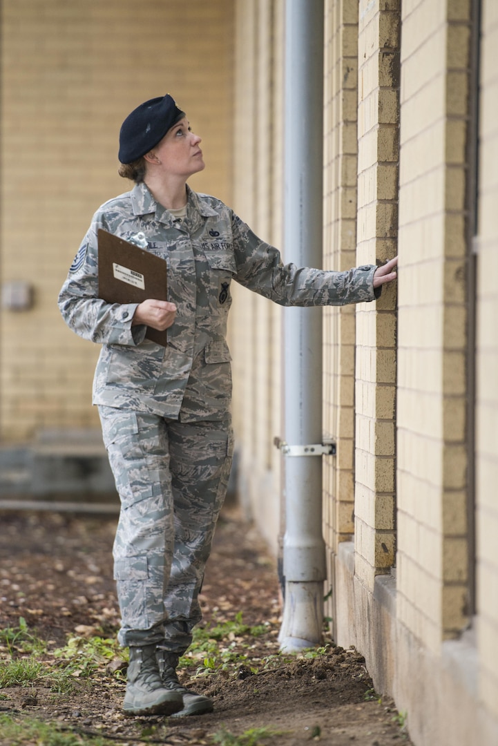 Technical Sgt. Michelle Aberle, 802nd Security Forces Squadron installation security, leaves the Base Defense Operation Center after conducting a building security check May 9, 2017, at Joint Base San Antonio-Lackland, Texas.  Aberle provides force protection for base personnel, equipment and facilities from threats to include intrusion by unauthorized people. 