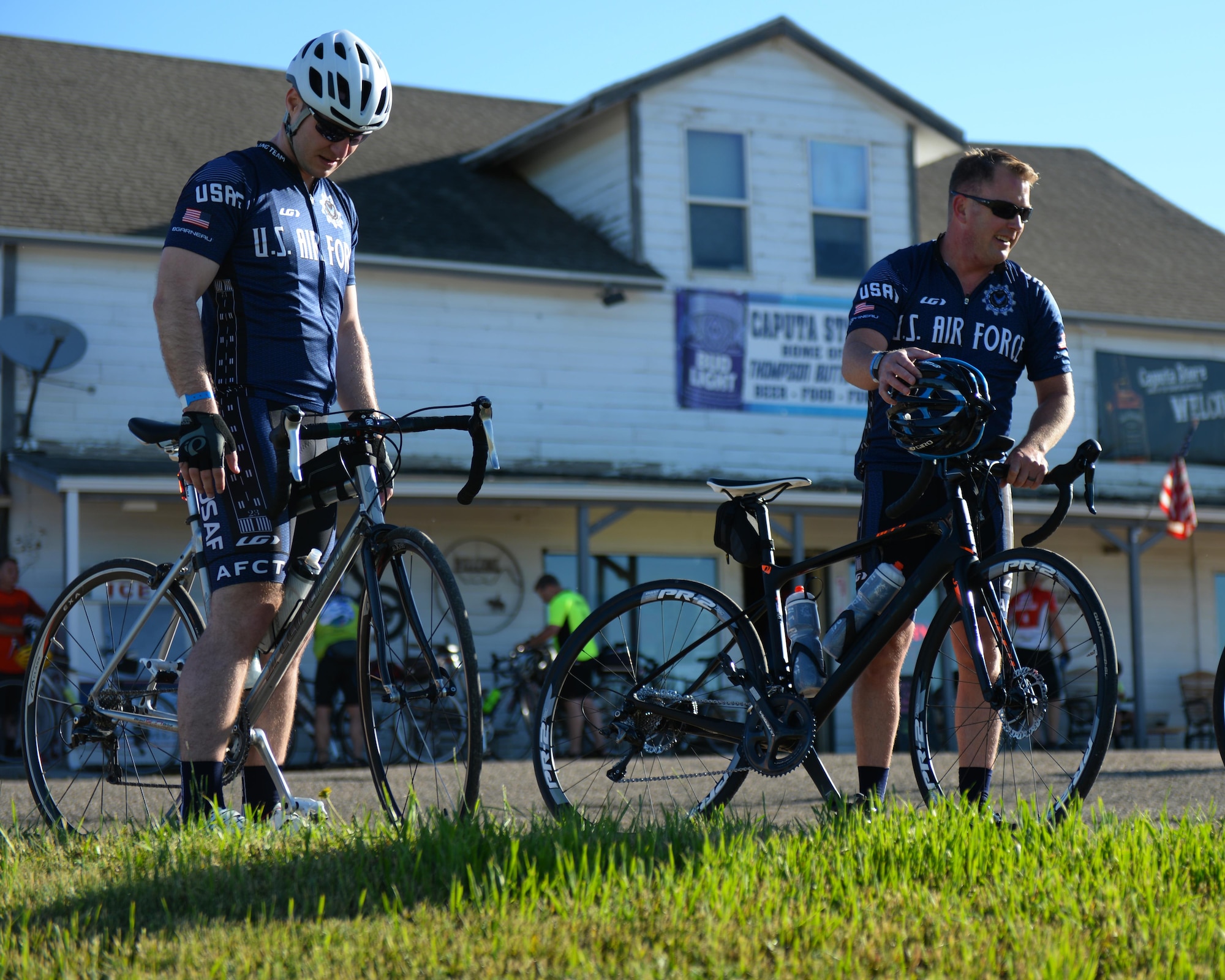 Maj. Anthony Bares, the director of inspections assigned to the 28th Bomb Wing Inspector General office, and Capt. Eben Engler, a B-1 Bomber weapon systems officer assigned to the 34th Bomb Squadron, prepare to continue the Ride Across South Dakota bike tour in Caputa, S.D., June 4, 2017. The Air Force Cycling Team has over 150 members, and supports other cyclists during the Register’s Annual Great Bicycle Ride Across Iowa whether it is promoting the Air Force or fixing bicycles on the route. (U.S. Air Force photo by Airman Nicolas Z. Erwin)